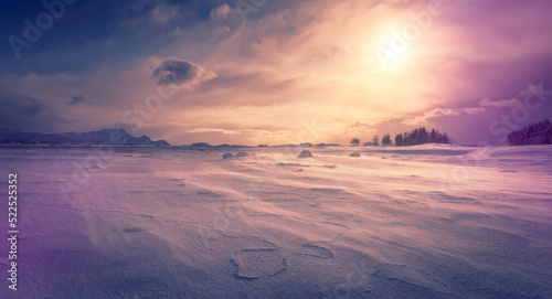 Awesome Winter Scenery. Wonderful wintry valley with snow-cowered river during sunset. Frosty morning with Snowfall and wind. Amazing nature background. Toned creative image. Norway. Lofoten islands