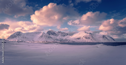 Snowcapped mountains, glacier lagoon, blue perfect sky with clouds. Wonderful winter landscape of frosty, sunny day. Stunning view of winter nature. Wonderful Wintry Landscape. Scenic image of Norway