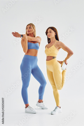 Wallpaper Mural Preparing for the fitness exercises. Beautiful women in sportive clothes is indoors in the studio Torontodigital.ca