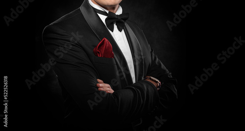 Element of the image of a man dressed in a tuxedo on a dark background.