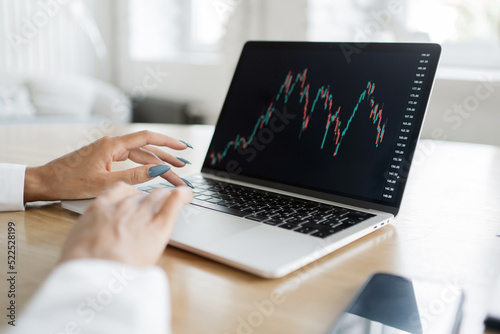 Investor trading on stock exchange online chart laptop screen