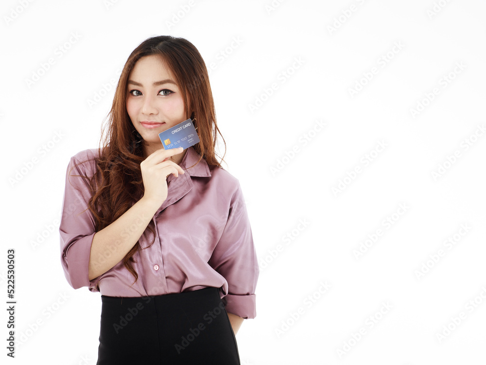 Beautiful Asian woman holding a credit card mockup happily shows her smile and self-confidence against a white background. Beautiful Asian woman holding a credit card mockup happily shows her smile and self-confidence against a white background.
