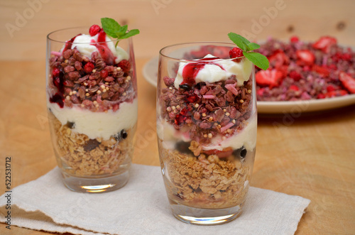 healthy breakfast granola with yogurt and berries on the table