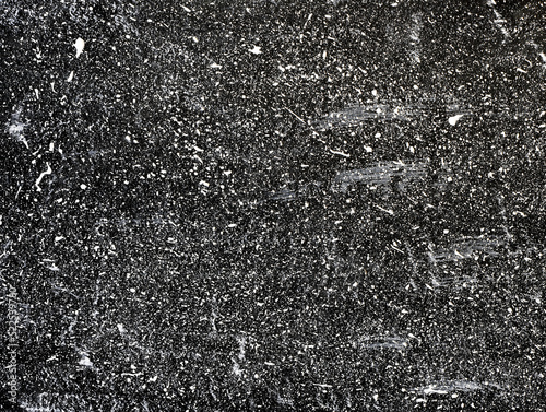 White ink droplets of paint on black background. Splatter background. Abstract dark wallpaper. Dark shabby concrete wall. stained texture. Painted backdrop.
