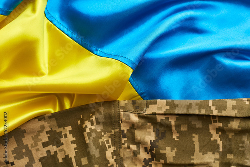 Ukraine flag and military uniform of ukrainian soldier. Armed Forces of Ukraine photo