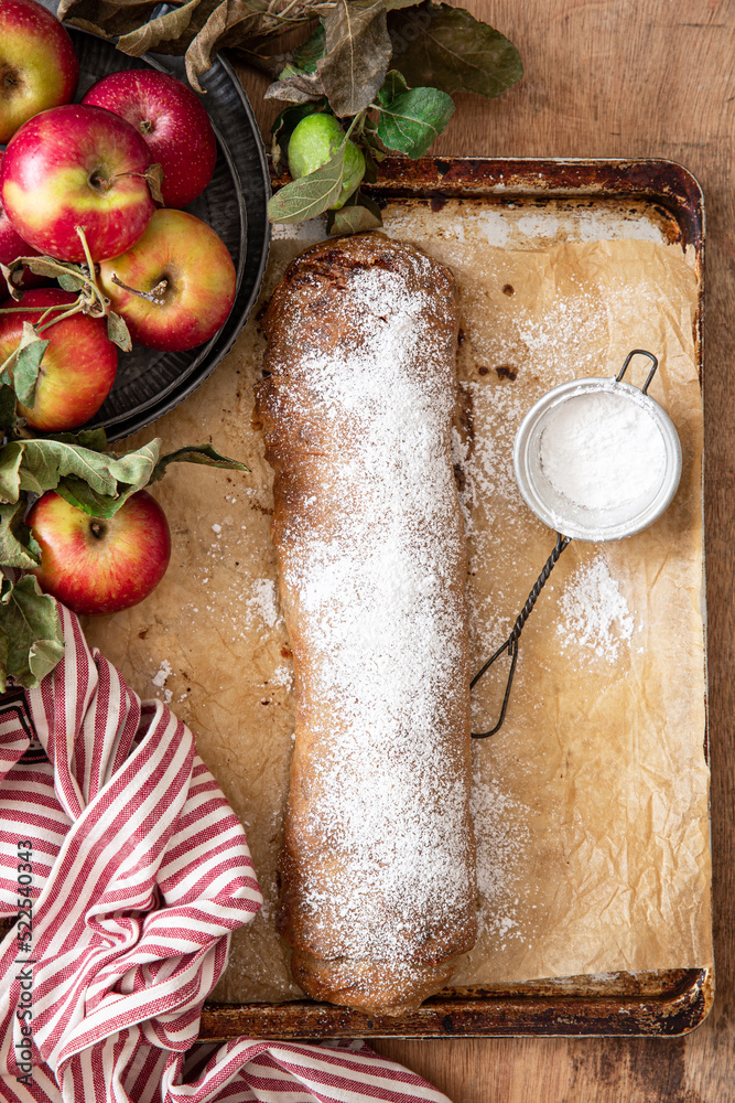 Fototapeta premium Homemade traditional Apple strudel on a wooden background