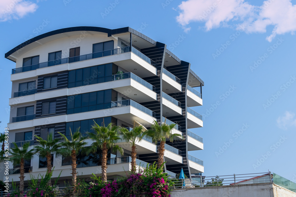 Modern apartment building with large balconies on a sunny day. Modern apartment building with large balconies on a sunny day.