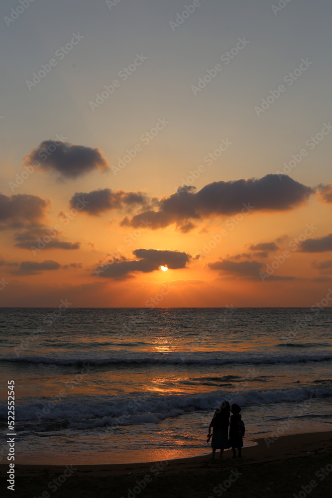Fototapeta premium The sun sets below the horizon on the Mediterranean Sea in northern Israel.