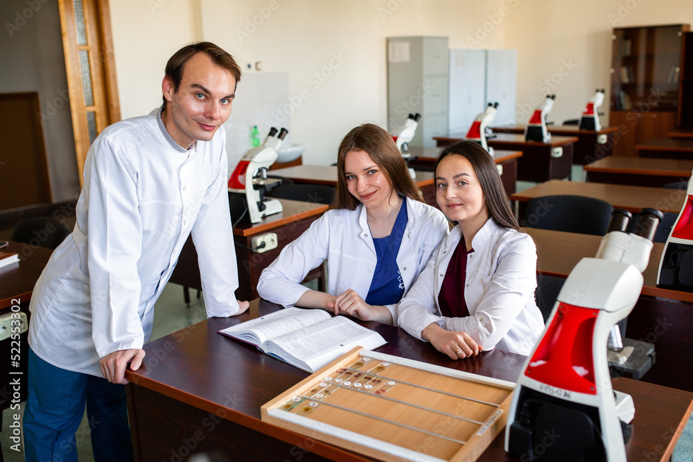 Medical students in the classroom study smears in the laboratory. Young scientist doing some research