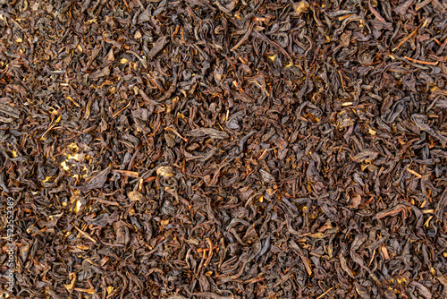 Dry black tea leaves close up. Dark background. Food and drink cooking. Texture