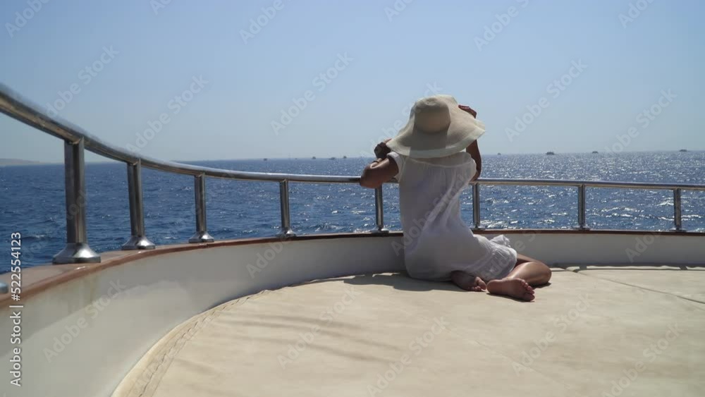 Woman relaxing on board of sailing yacht in the Red Sea, Egypt Woman relaxing on board of sailing yacht in the Red Sea, Egypt