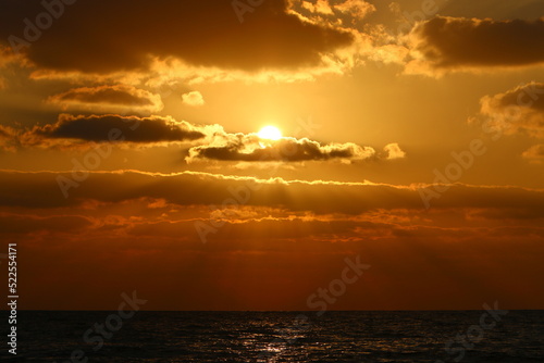 Fototapeta Naklejka Na Ścianę i Meble -  The sun sets below the horizon on the Mediterranean Sea in northern Israel.