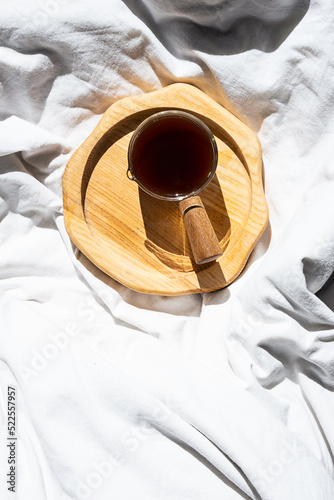 Cozy homely scene with coffee cup in bed. Morning concept.