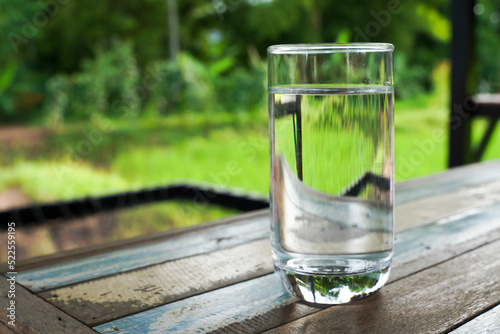 Glass of water outdoors, glass of water and ice on soft background,