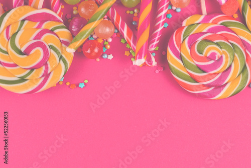 Colorful candies on a red background. Lollipop. Top view. Copy space.