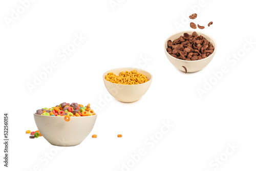 Colorful cereal box for morning breakfast. Corn flakes falling to the white bowl. Motion.