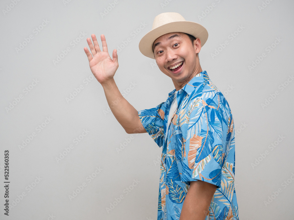 Cheerful man wear hat beach shirt turn around say hello Cheerful man wear hat beach shirt turn around say hello