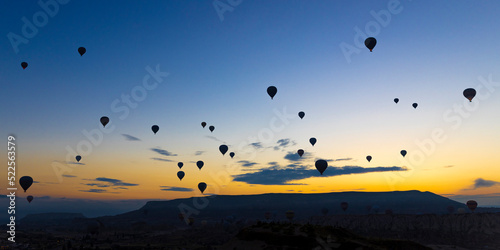 hot air balloons take off at sunrise over the city of goreme