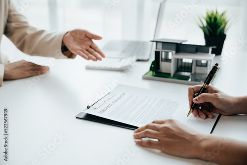Close up of business s hands selling and signing agreement paperwork for loan financial to buying the house properties.