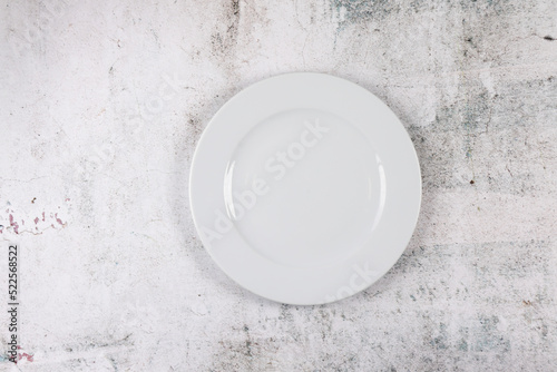 Grey stone surface with white dinner plate place setting