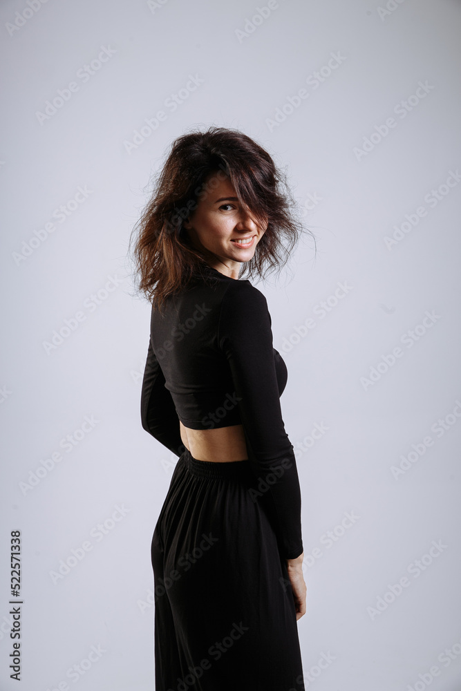 emotional beautiful girl in black clothes on a gray background emotional beautiful girl in black clothes on a gray background