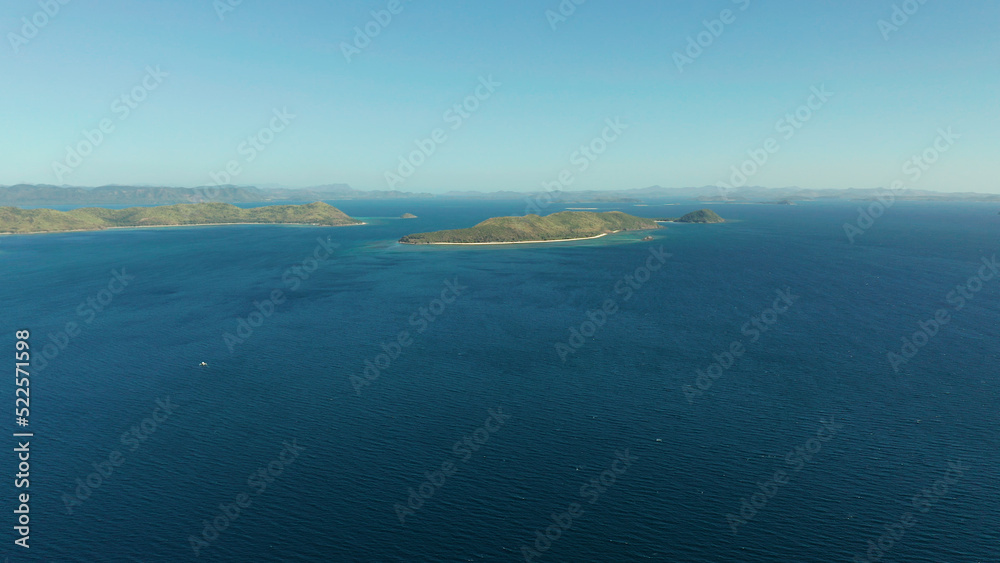 aerial view small island group in province of Palawan. Busuanga, Philippines. Seascape, islands covered with forest, sea with blue water. tropical landscape, travel concept