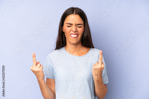 hispanic pretty woman feeling provocative, aggressive and obscene, flipping the middle finger, with a rebellious attitude