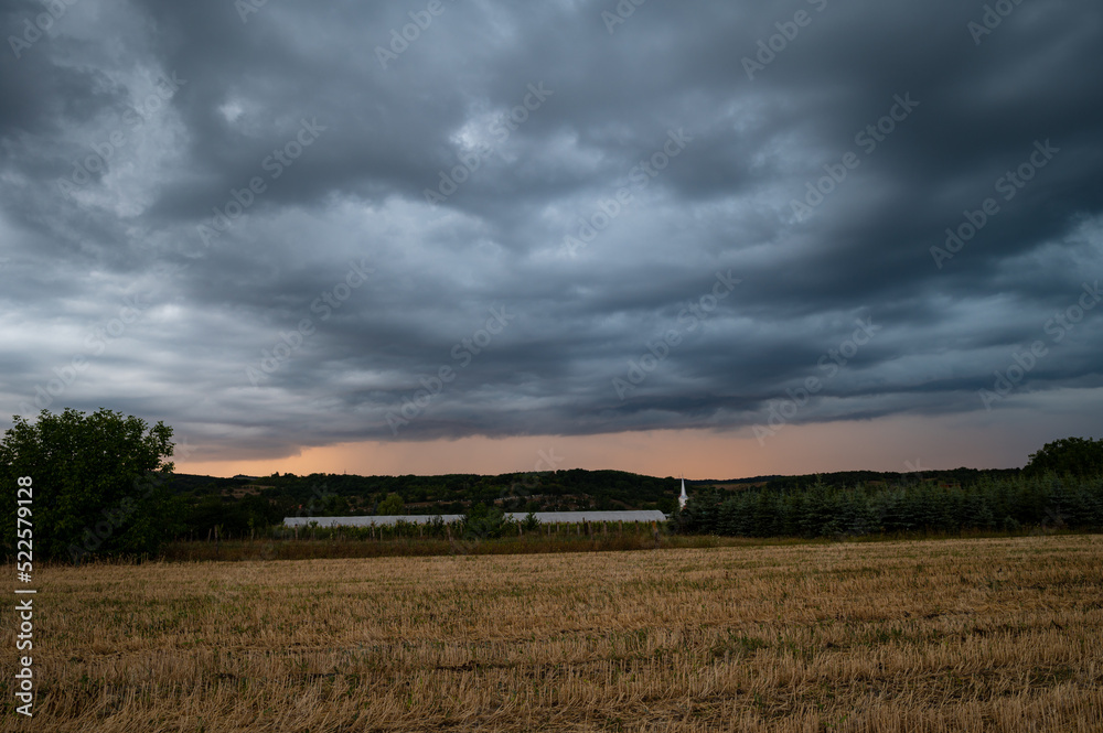 Fototapeta premium Dramatic cloudy skies as a twilight thunderstorm sweeps over the Romanian countryside