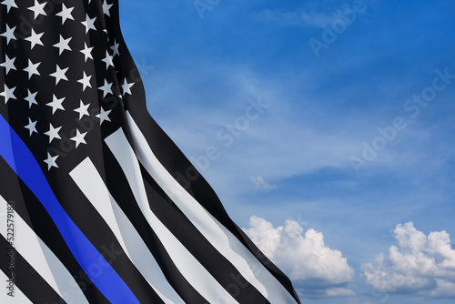 American flag with police support symbol Thin blue line on blue sky. American police in society as the force which holds back chaos, allowing order and civilization to thrive. 3d-rendering.