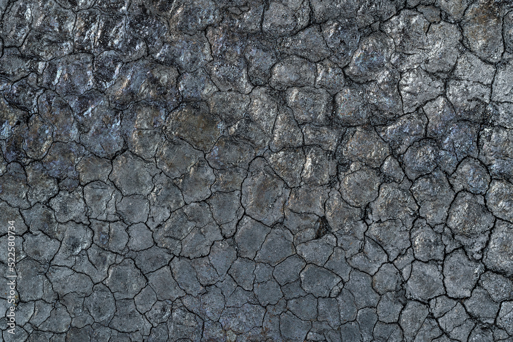 Fototapeta premium Black cracked texture of jet black surface of charcoal or soot close up