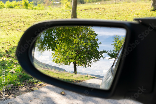Looking in the side rear-view mirror in the day of dreams