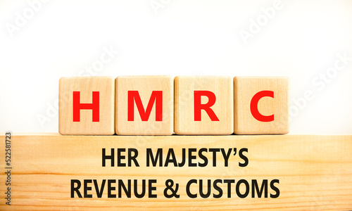 HMRC her majestys revenue and customs symbol. Concept words HMRC her majestys revenue and customs on blocks on beautiful white background. Business HMRC revenue and customs concept. Copy space. photo