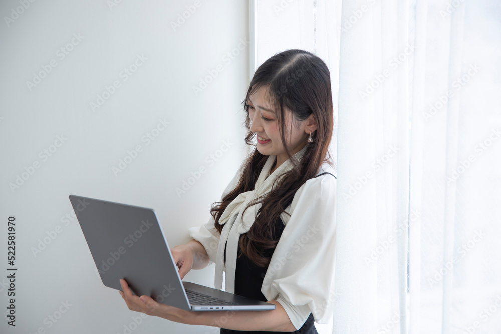 A working Japanese woman by remote work in the home office closeup A working Japanese woman by remote work in the home office closeup