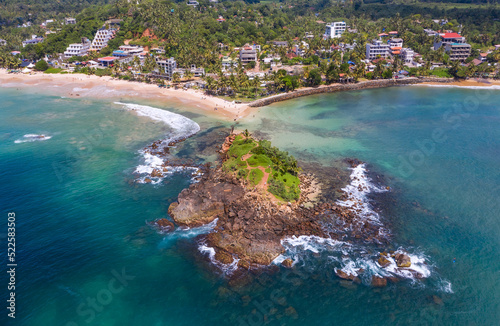 Bild auf Leinwand Mirissa sandy Parrot Rock island landmark aerial photo with a beautiful bay in Matara District on Sri Lanka