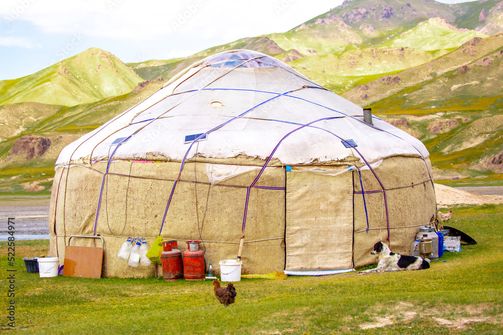 Yurt. National old house of the peoples of Kyrgyzstan and Asian countries. national housing. Yurts on the background of green meadows and highlands. Yurt camp for tourists in the mountains.