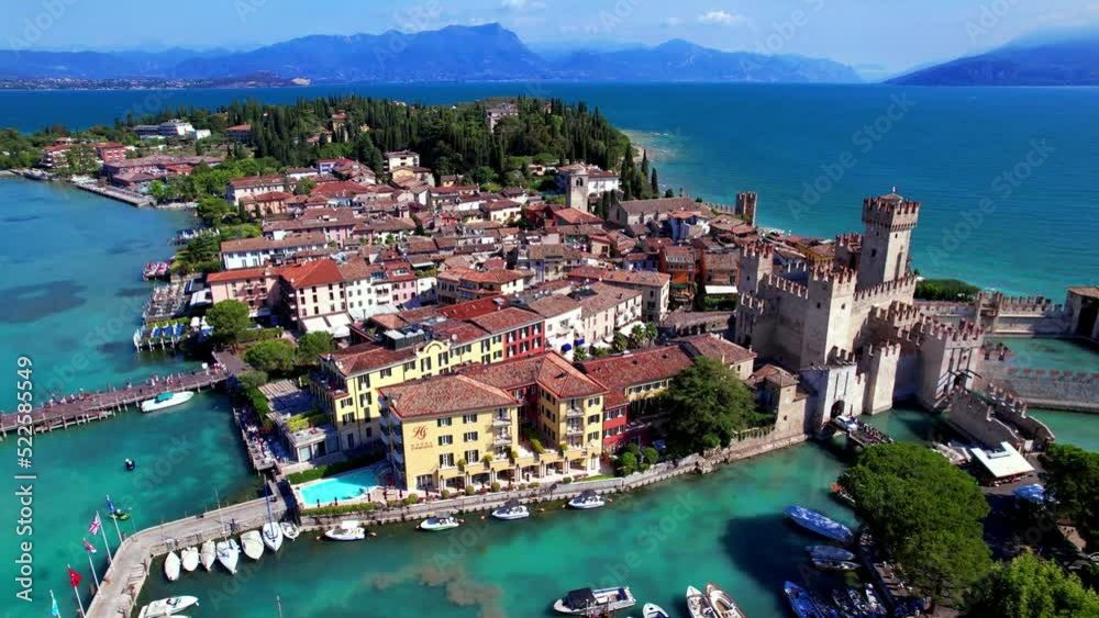 One of the most beautiful lakes of Italy  Lago di Garda aerial drone view of Sirmione town and medieval castle Scaligero.  Lombardy