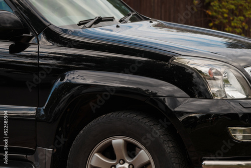 Side view of the front of the SUV. Elegant black car © Armands photography