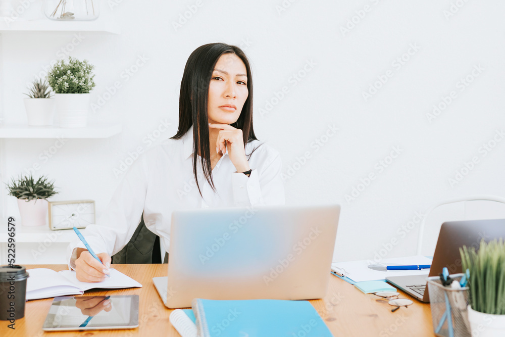 young asian business woman professional in formal wear clothes work in modern office using laptop, tablet, brainstorm and search for solutions, confident independent Asian girl solves problems