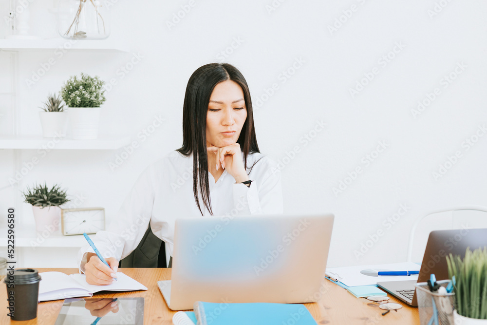 young asian business woman professional in formal wear clothes work in modern office using laptop, tablet, brainstorm and search for solutions, confident independent Asian girl solves problems young asian business woman professional in formal wear clothes work in modern office using laptop, tablet, brainstorm and search for solutions, confident independent Asian girl solves problems