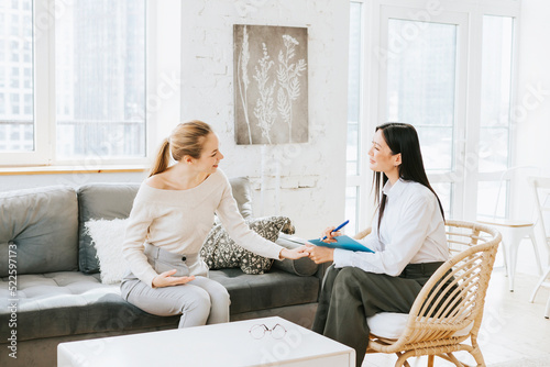 psychological consultation young Asian specialist psychologist or coach conducts a session for a patient of a young woman, problem solving, mental health