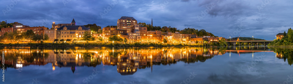 Augusta at Dusk - A panoramic dusk view of Downtown Augusta at shore of Kennebec River on a stormy Autumn evening. Maine, USA.