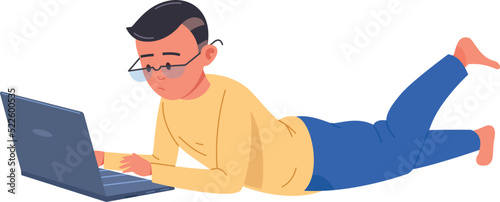 Boy in glasses laying on floor with laptop. Smart kid using computer