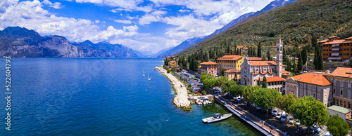 Fototapeta Naklejka Na Ścianę i Meble -  Scenic Lake Lago di Garda, Italy, aerial view of fishing village with colorful houses and boats - Castelletto di Brenzone.