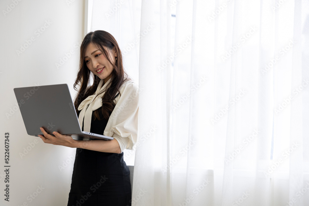 A working Japanese woman by remote work in the home office closeup A working Japanese woman by remote work in the home office closeup