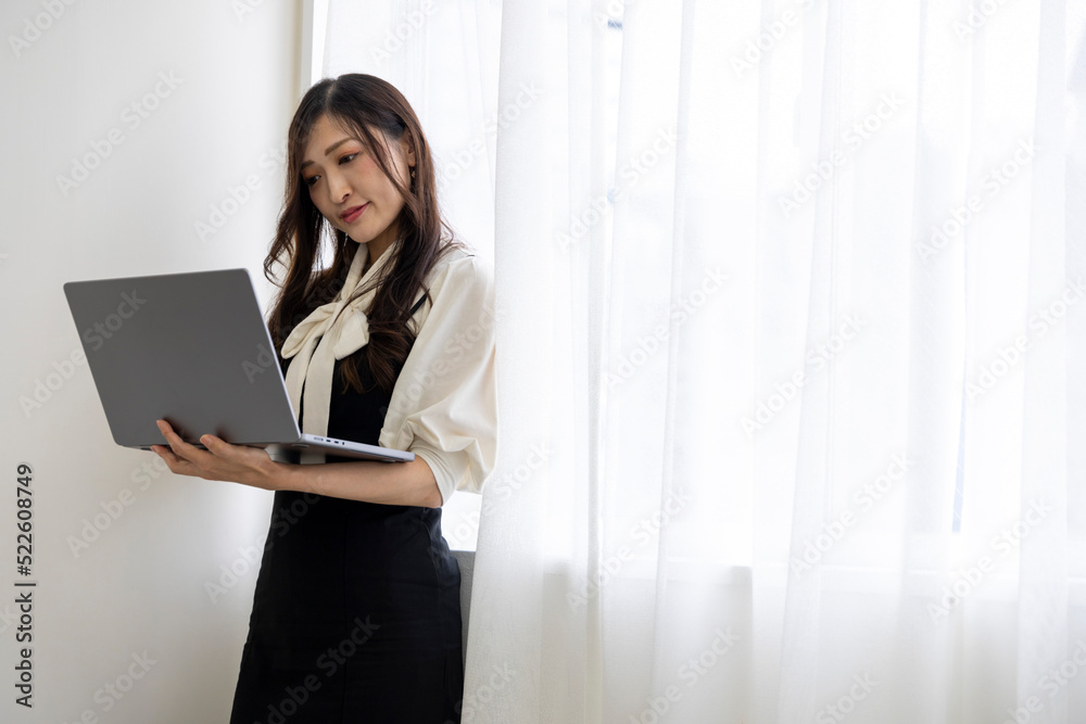 A working Japanese woman by remote work in the home office closeup A working Japanese woman by remote work in the home office closeup