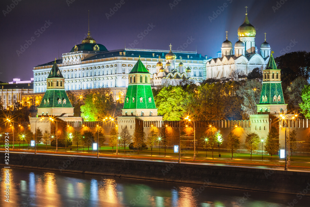 Kremlin towers illuminated at evening with river reflection, Moscow, Russia