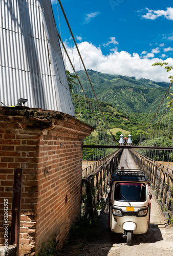 Santa Fe de Antioquia - Colombia. July 29, 2022. Old western suspension bridge over the Cauca River photo