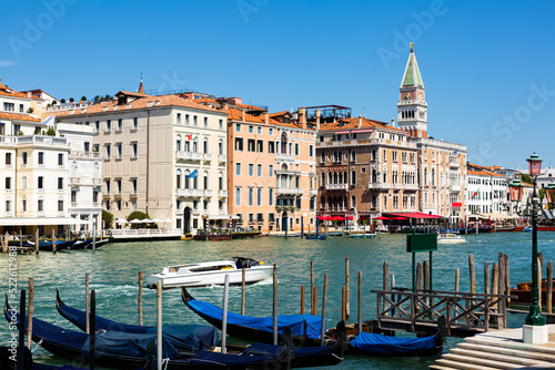 Scenic view of Venetian Grand Canal with old colorful architecture of central districts and St Mark Campanile in sunny day, Italy