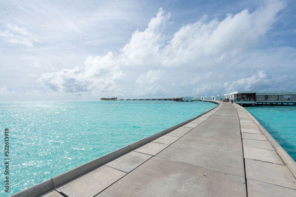 Maldives resort bridge in tropical, exotic paradise with turquoise water