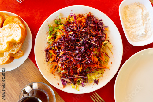 Traditional Turkish kebab salad of shredded white and red cabbage, carrots dressed with olive oil and seasoned richly with piquant tart sumac photo